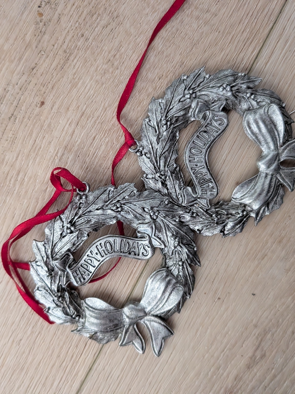 Silver Toned 'Happy Holidays' Wreath Ornament with Red Ribbon